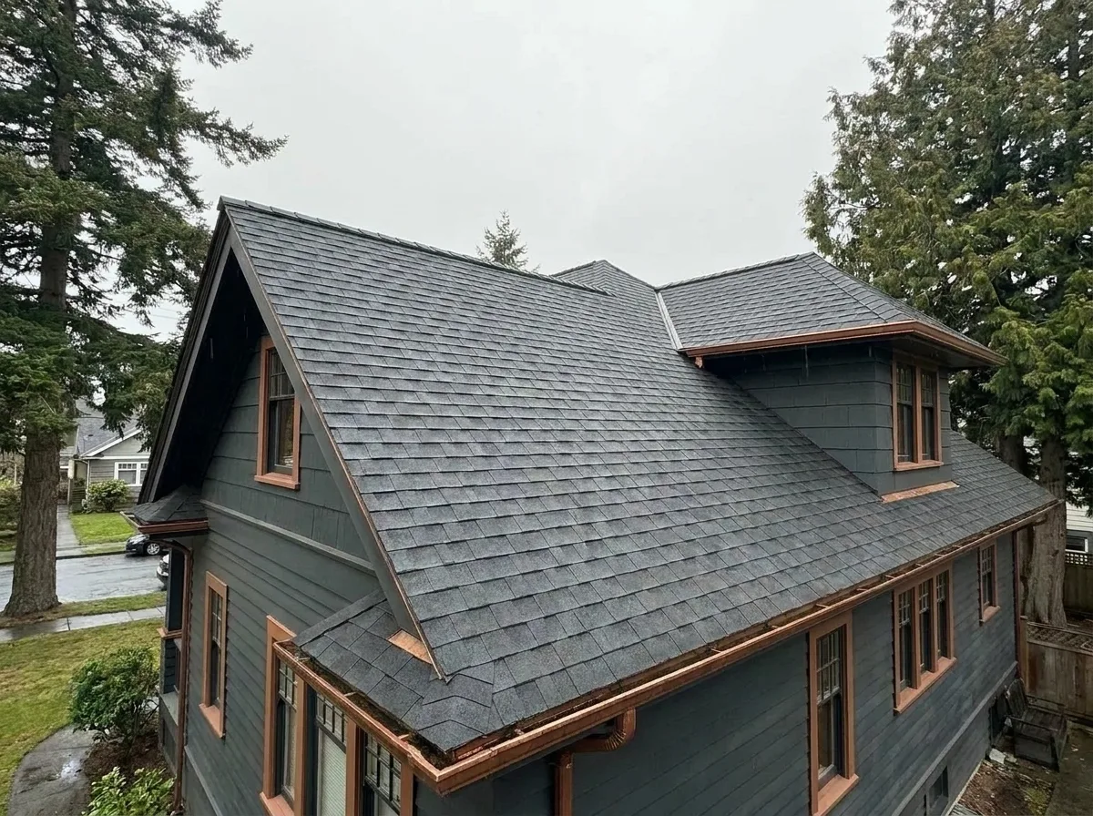 Completed roofing system replacing cedar shakes on an older Greater Victoria home, with new decking and ventilation